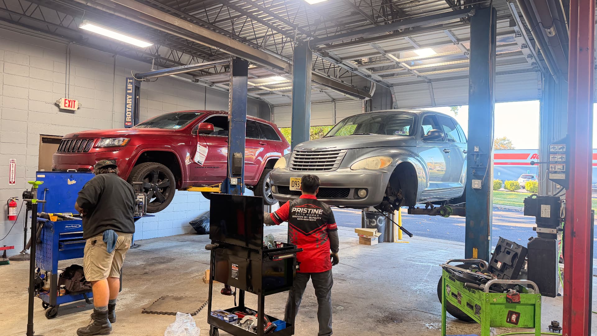 Inside the shop: technicians at work on vehicles raised on the lifts