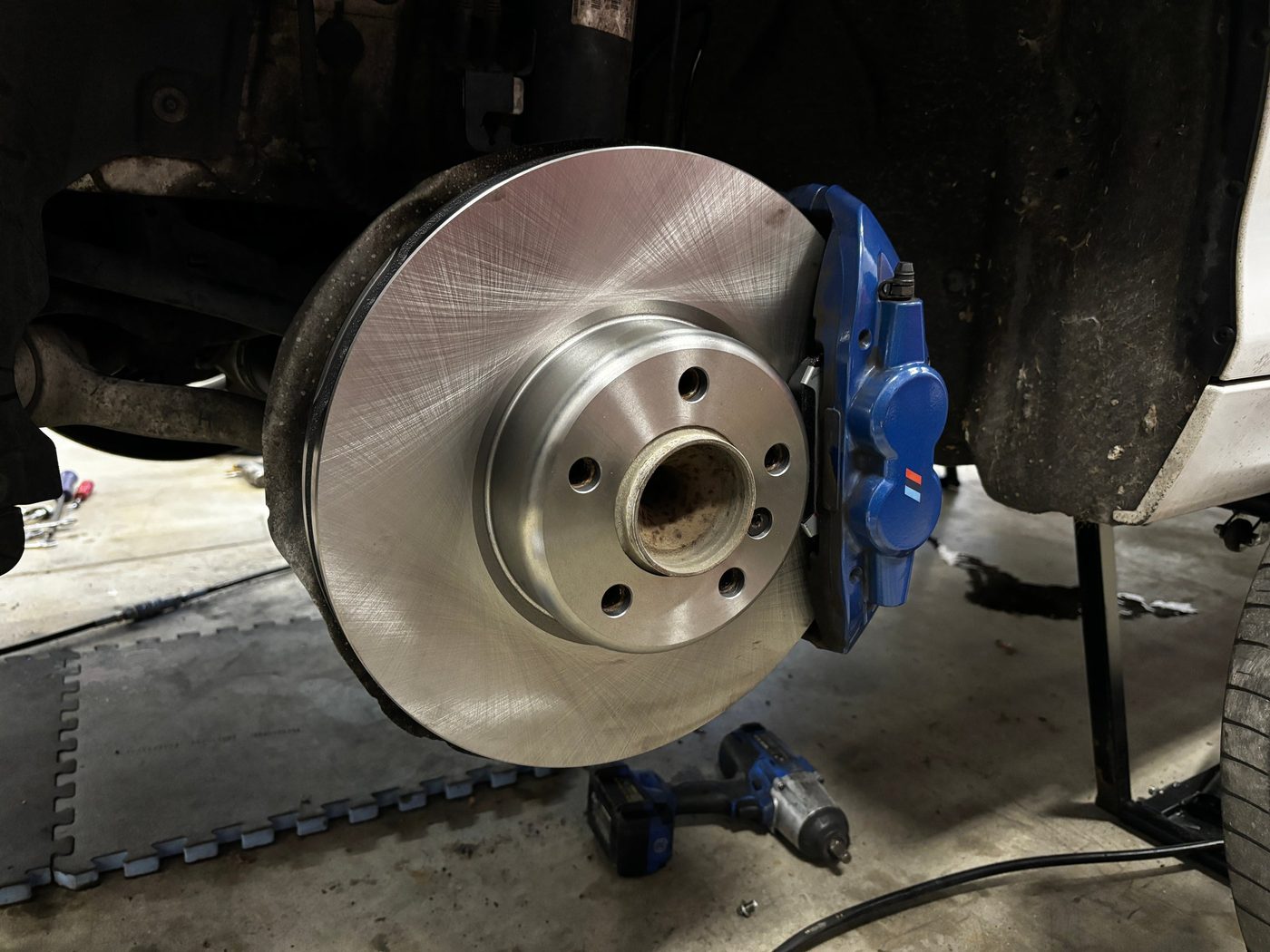 New blue brake caliper and rotor